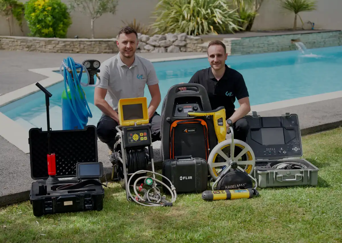 men standing next to a pool with equipment