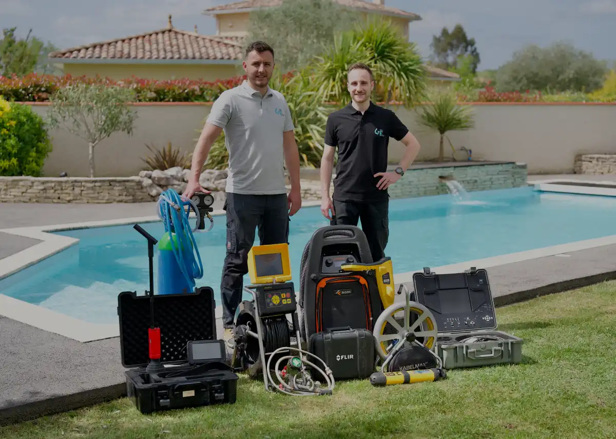 two men standing next to a pool