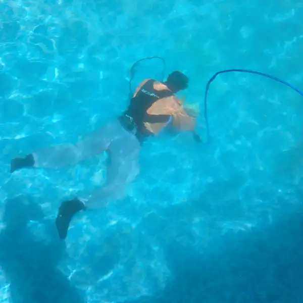a person underwater with a rope